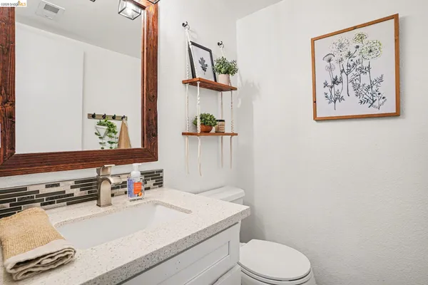 a bathroom with a toilet a sink and a mirror