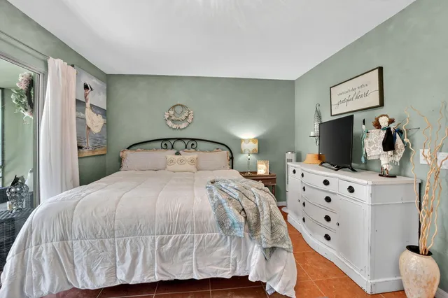 a balcony with furniture and a potted plant