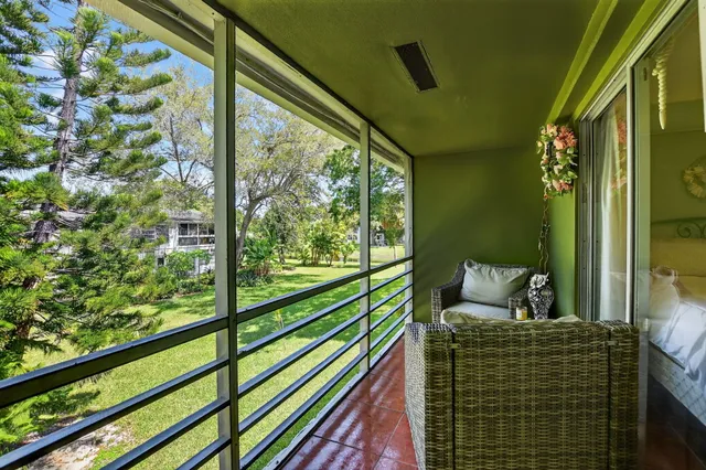 a view of a lake from a balcony with chairs