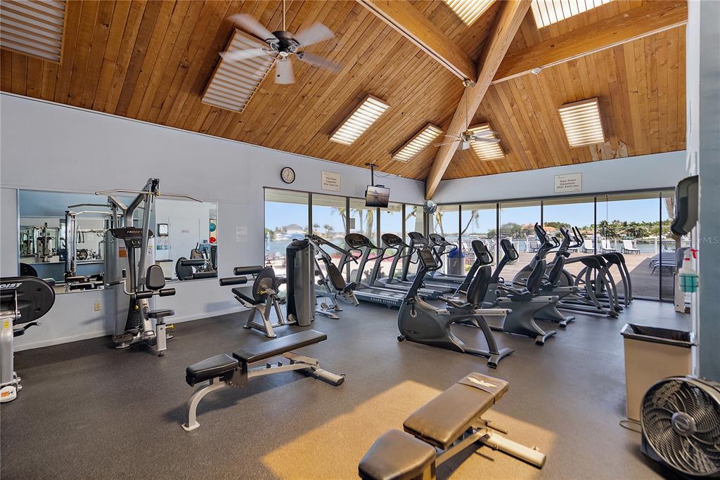 9415 Blind Pass Road, Unit 905 St. Pete Beach, FL 33706 - Photo 35 of 51 a view of a room with gym equipment