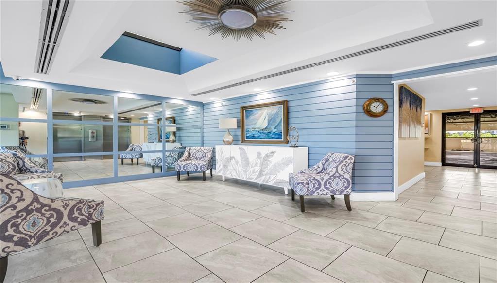 9415 Blind Pass Road, Unit 905 St. Pete Beach, FL 33706 - Photo 41 of 51 a living room with furniture and a large window