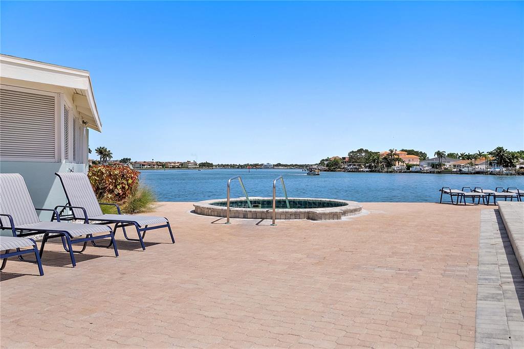9415 Blind Pass Road, Unit 905 St. Pete Beach, FL 33706 - Photo 6 of 51 a view of a swimming pool and lake view