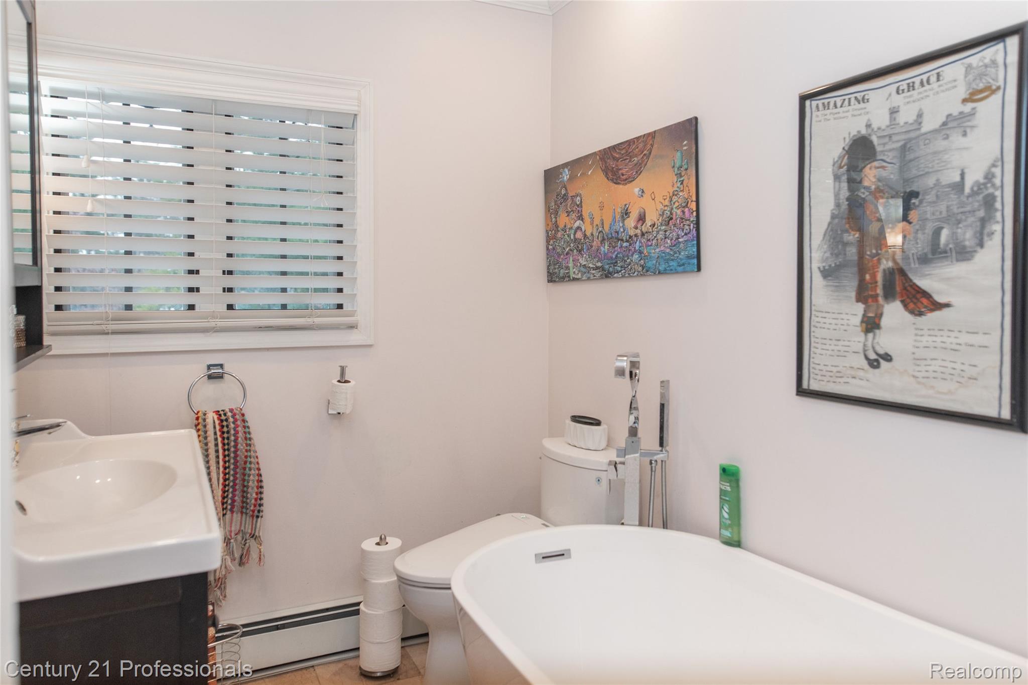 910 West Pine Tree Road West Lake Orion, MI 48362 - Photo 24 of 52 Full bath featuring a baseboard radiator, a freestanding bath, and vanity