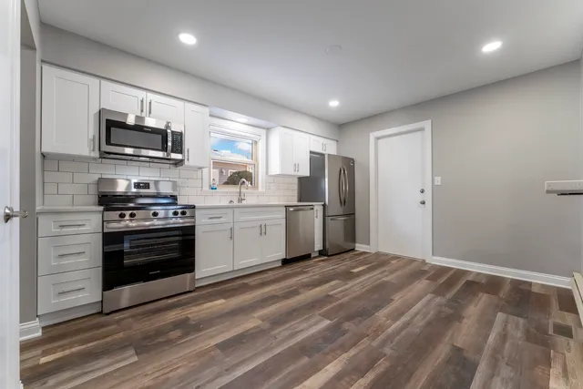 a kitchen with stainless steel appliances a refrigerator stove and microwave