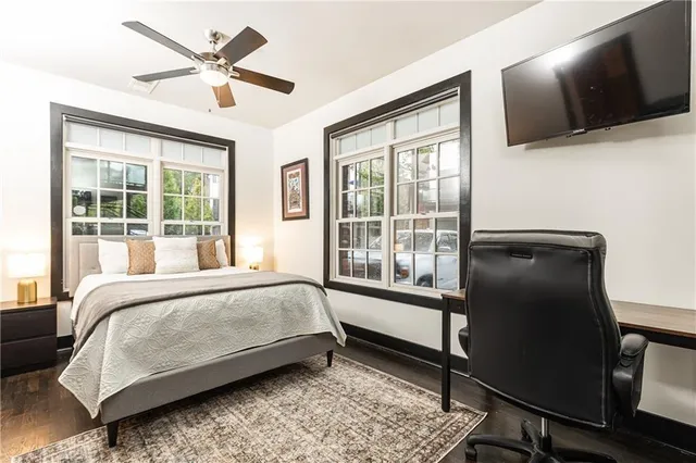 a bedroom with a large bed and a flat tv screen on a dresser