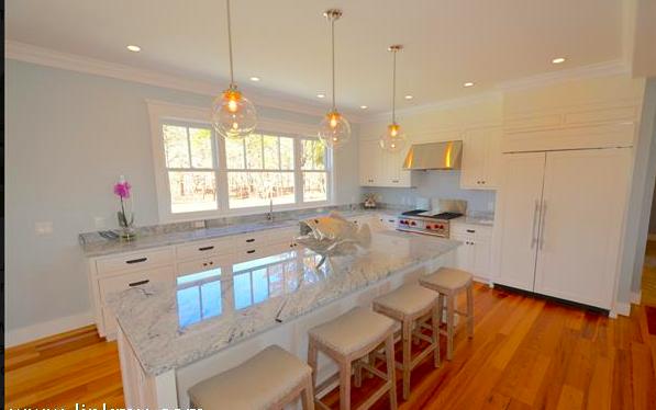 25 Meshacket Road Edgartown, MA 02539 - Photo 7 of 27 a kitchen with stainless steel appliances granite countertop a sink a stove and a wooden floors