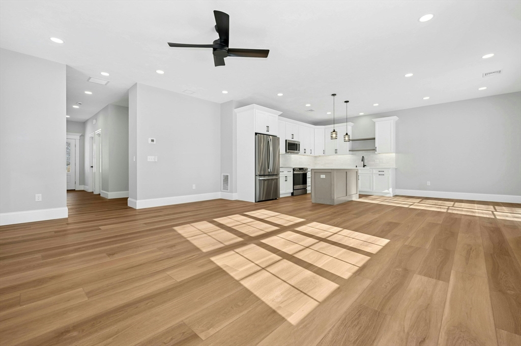 2 B Wilson Road, Unit B Millbury, MA 01527 - Photo 11 of 40 a large kitchen with kitchen island a sink stainless steel appliances and cabinets