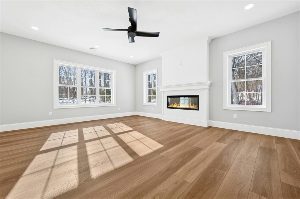 2 B Wilson Road, Unit B Millbury, MA 01527 - Photo 13 of 40 a view of an empty room with a window and wooden floor
