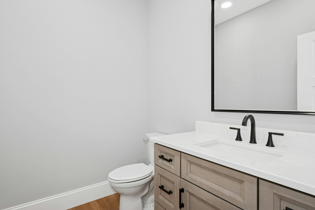 2 B Wilson Road, Unit B Millbury, MA 01527 - Photo 17 of 40 a bathroom with a toilet sink and mirror