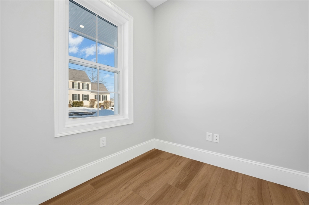 2 B Wilson Road, Unit B Millbury, MA 01527 - Photo 19 of 40 a view of an empty room with wooden floor and a window