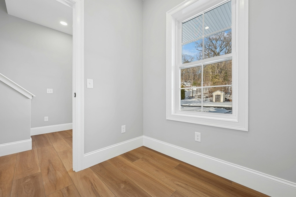 2 B Wilson Road, Unit B Millbury, MA 01527 - Photo 20 of 40 an empty room with wooden floor and windows