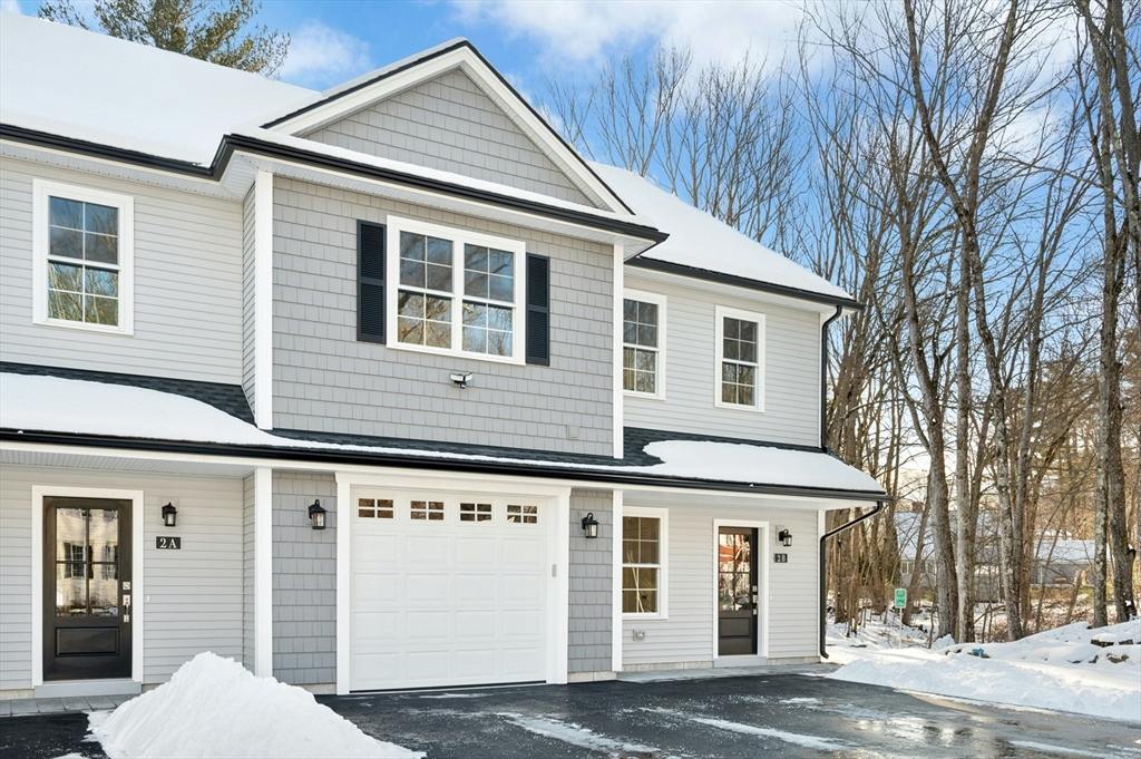 2 B Wilson Road, Unit B Millbury, MA 01527 - Photo 2 of 40 a view of a white house with a large windows