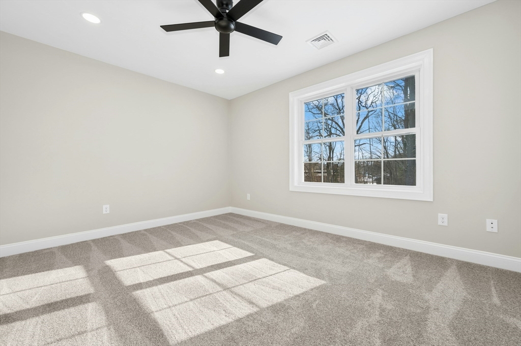 2 B Wilson Road, Unit B Millbury, MA 01527 - Photo 32 of 40 a view of an empty room with a window and wooden floor