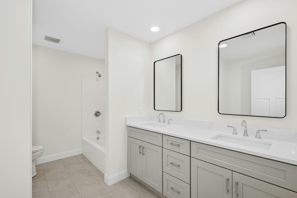 2 B Wilson Road, Unit B Millbury, MA 01527 - Photo 34 of 40 a bathroom with double vanity sink and a mirror