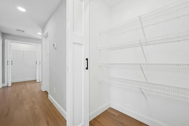 a view of a room with wooden floor