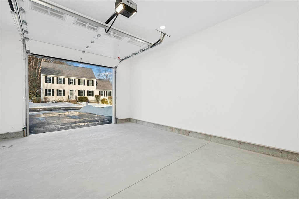 2 B Wilson Road, Unit B Millbury, MA 01527 - Photo 37 of 40 an empty room with ceiling fan and windows