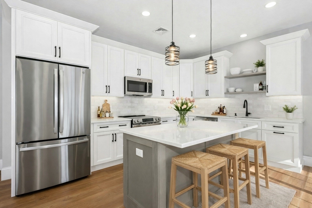 2 B Wilson Road, Unit B Millbury, MA 01527 - Photo 4 of 40 a kitchen with appliances a counter space and a refrigerator