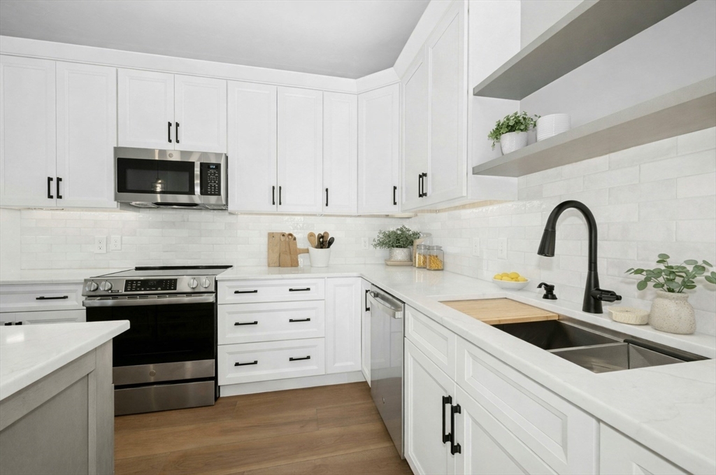 2 B Wilson Road, Unit B Millbury, MA 01527 - Photo 5 of 40 a kitchen with white cabinets and white appliances