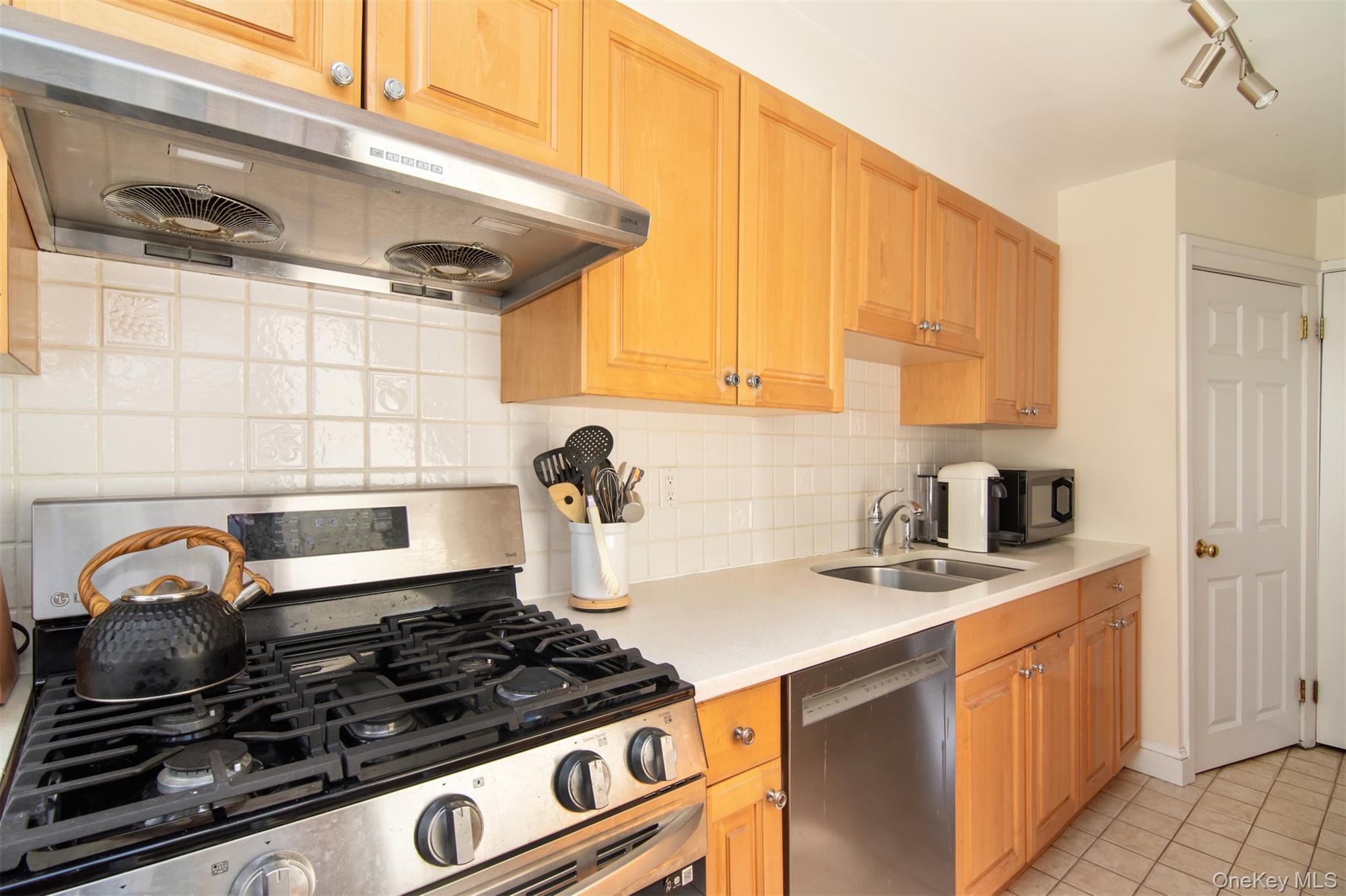 74 Kensington Road Bronxville, NY 10708 - Photo 17 of 33 a kitchen with granite countertop a stove sink and cabinets