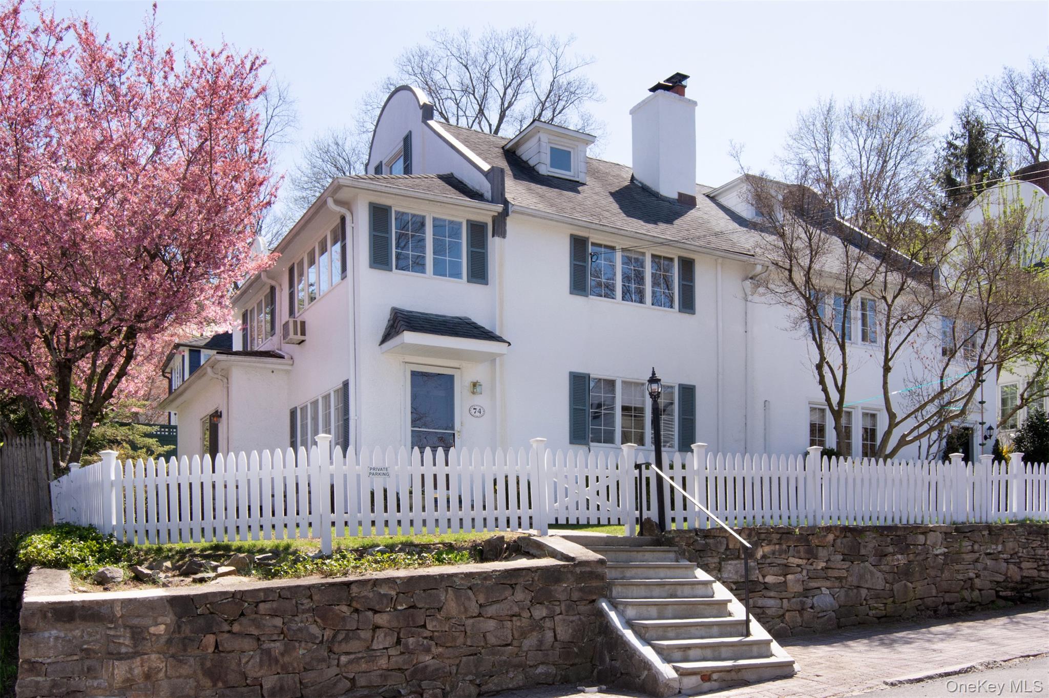 74 Kensington Road Bronxville, NY 10708 - Photo 2 of 33 a front view of a house with a garden