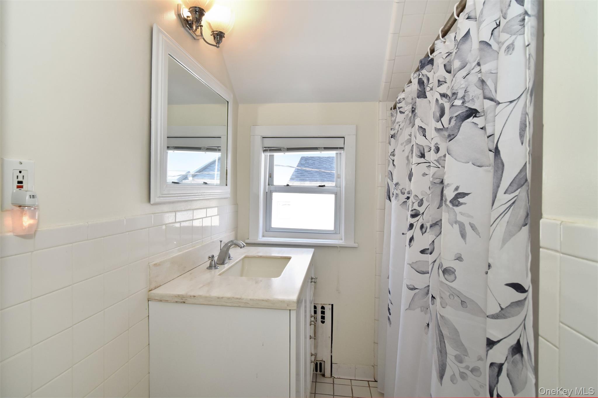 74 Kensington Road Bronxville, NY 10708 - Photo 23 of 33 a bathroom with a granite countertop sink and a mirror