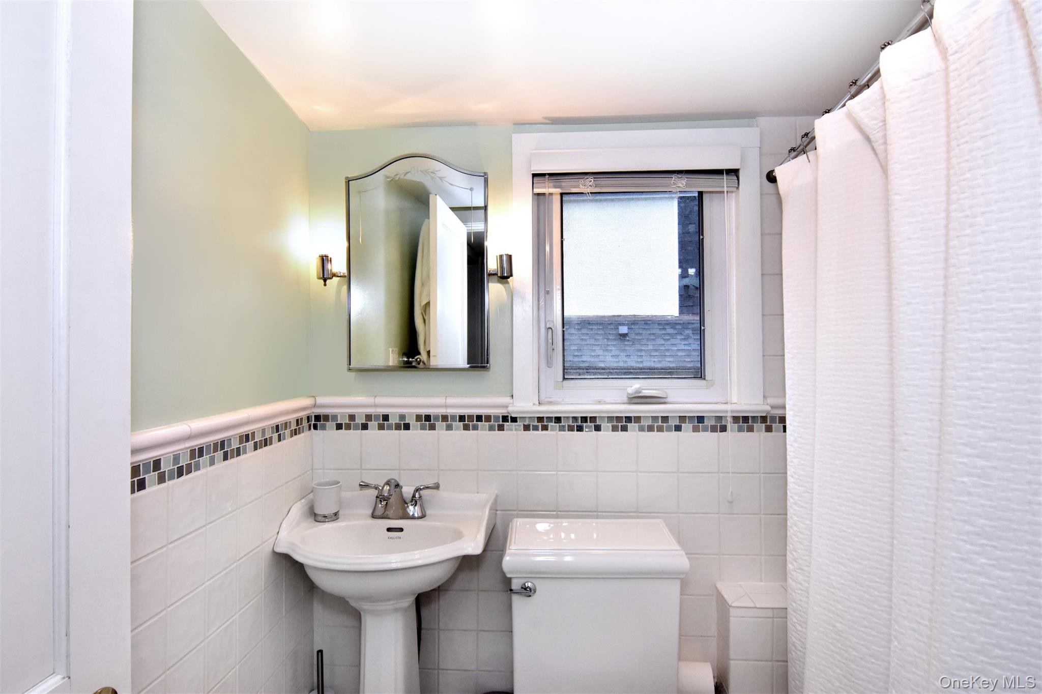 74 Kensington Road Bronxville, NY 10708 - Photo 25 of 33 a bathroom with a sink mirror and a toilet