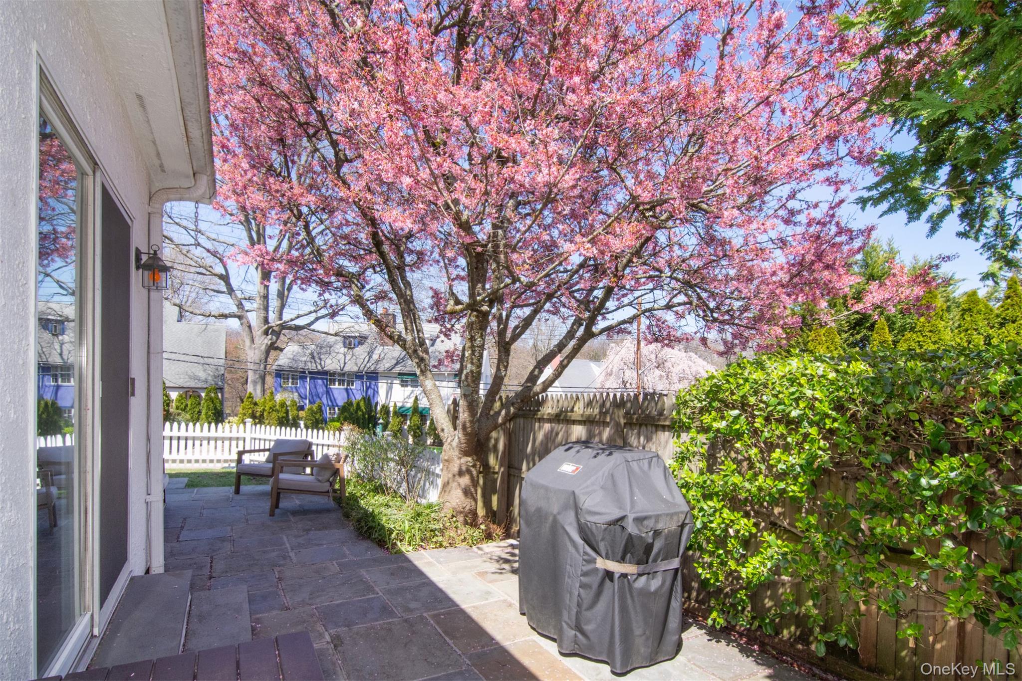 74 Kensington Road Bronxville, NY 10708 - Photo 26 of 33 a view of a patio with table and chairs and potted plants