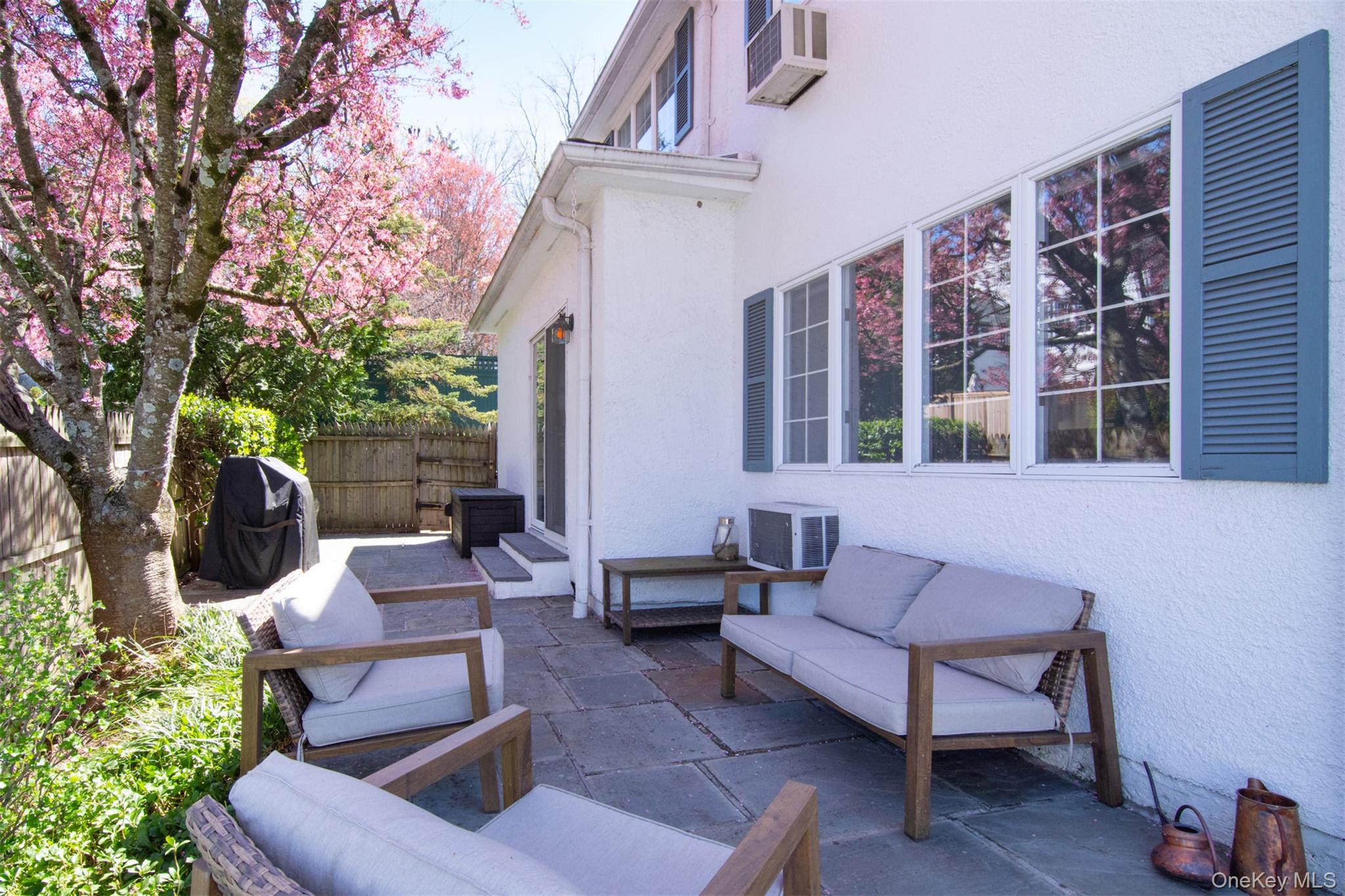 74 Kensington Road Bronxville, NY 10708 - Photo 29 of 33 a outdoor space with patio the couches and a fireplace with wooden floor