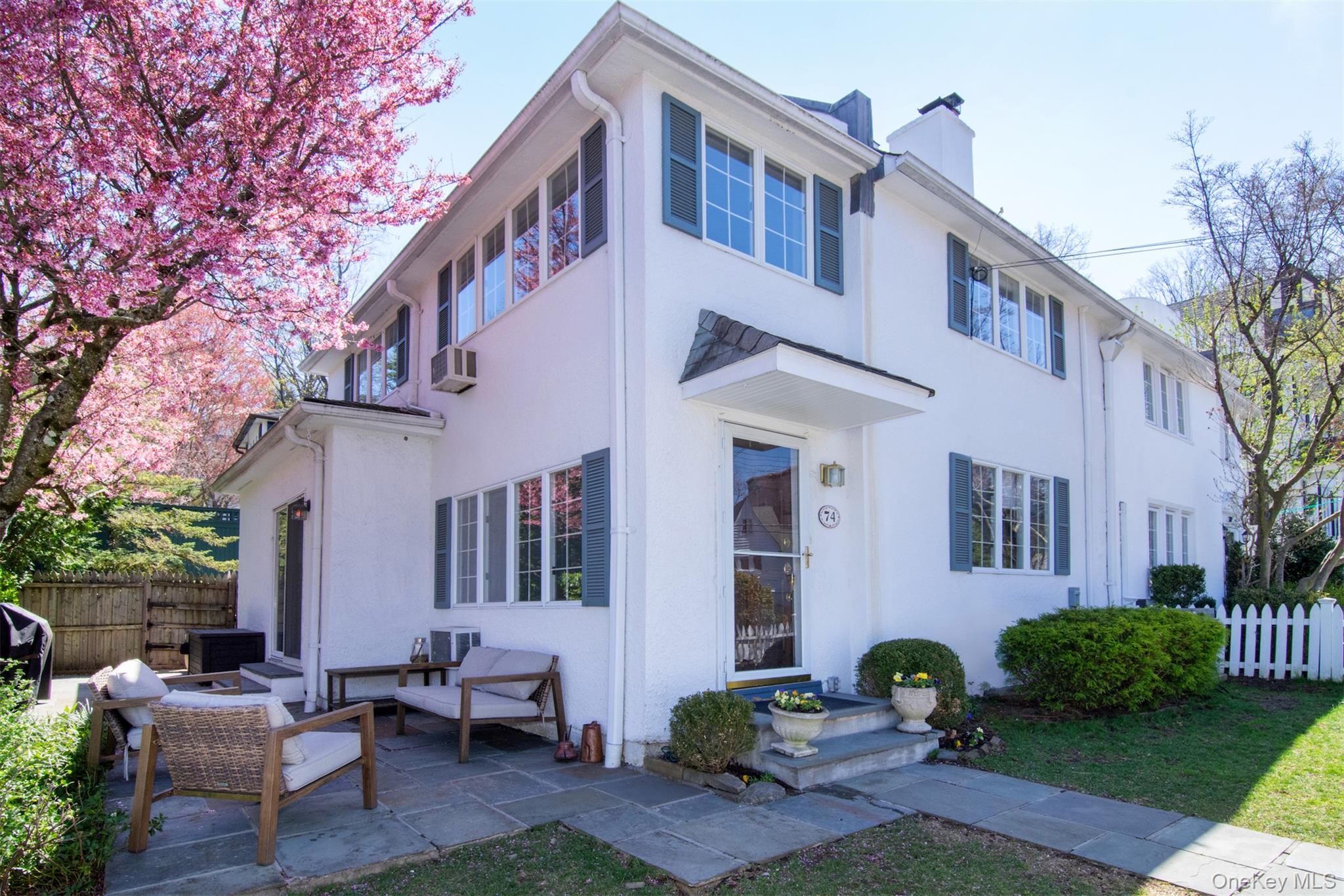74 Kensington Road Bronxville, NY 10708 - Photo 3 of 33 a front view of a house with garden and plants