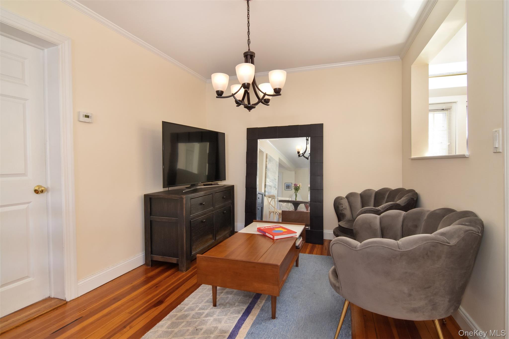 74 Kensington Road Bronxville, NY 10708 - Photo 9 of 33 a living room with furniture a flat screen tv and a window
