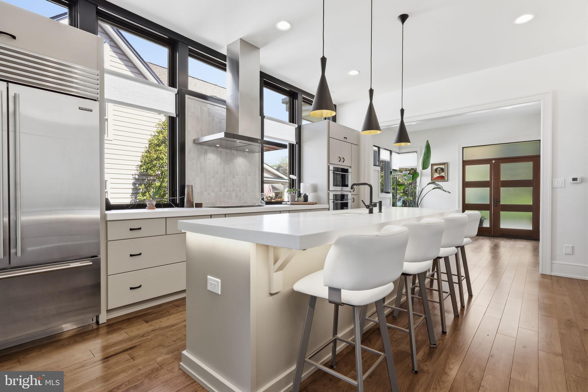 94 East Street Doylestown, PA 18901 - Photo 24 of 65 a kitchen with stainless steel appliances kitchen island wooden floors and white cabinets