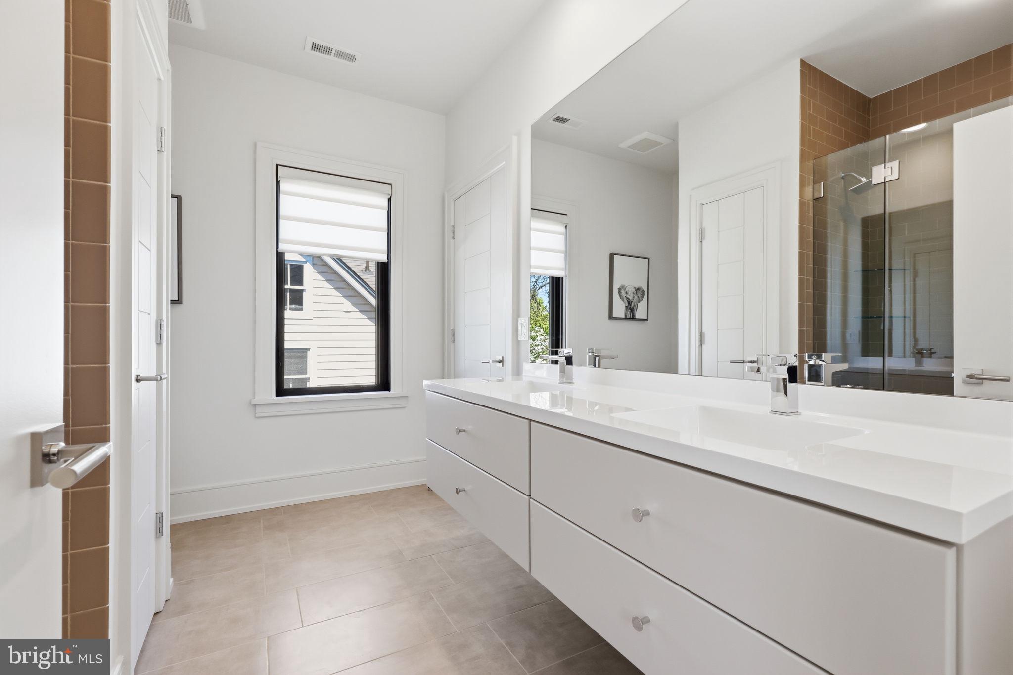 94 East Street Doylestown, PA 18901 - Photo 45 of 65 a bathroom with double sink and a mirror