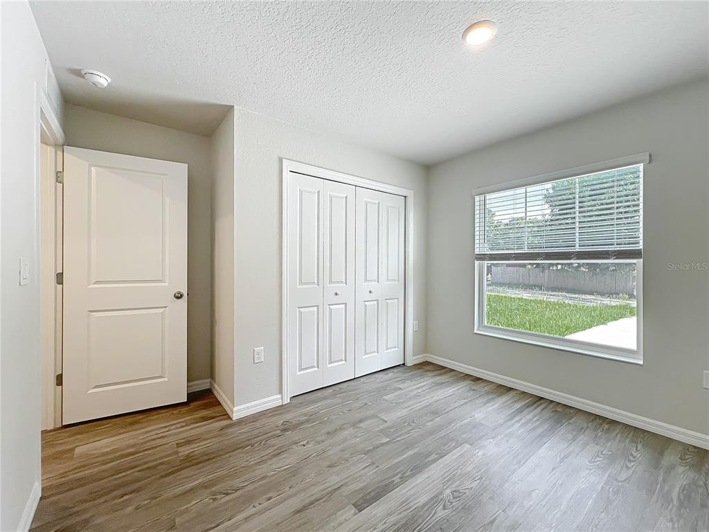 111 East Harvard Street Inverness, FL 34452 - Photo 19 of 21 an empty room with wooden floor and windows
