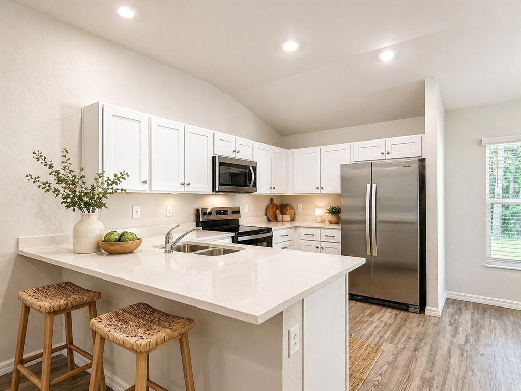 111 East Harvard Street Inverness, FL 34452 - Photo 6 of 21 a kitchen with a refrigerator a microwave a sink and chairs