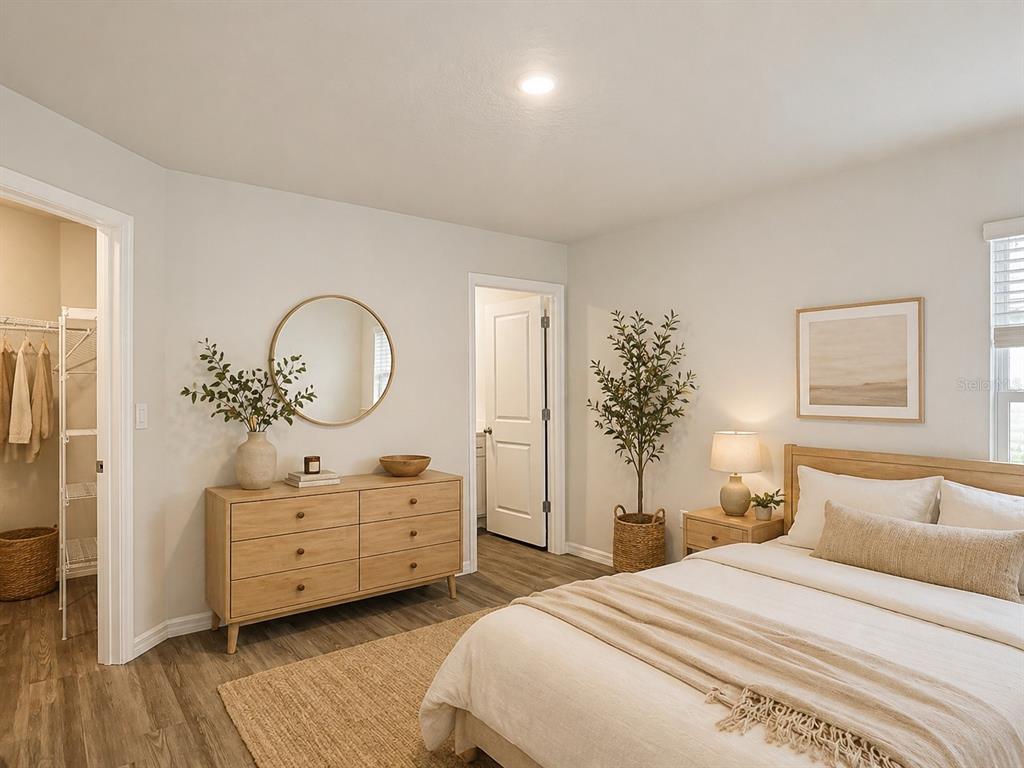 111 East Harvard Street Inverness, FL 34452 - Photo 9 of 21 a bedroom with a bed and a chandelier