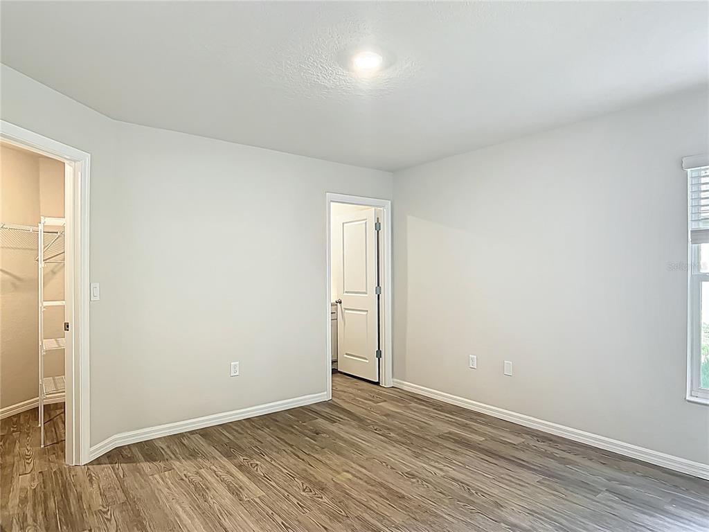 111 East Harvard Street Inverness, FL 34452 - Photo 10 of 21 an empty room with wooden floor and windows