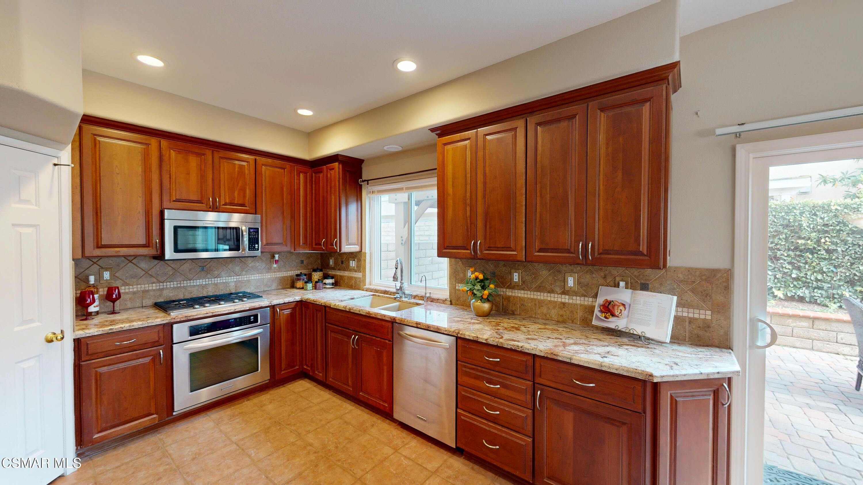 1708 Starpine Way Simi Valley, CA 93065 - Photo 21 of 60 a kitchen with a sink stove top oven and cabinets