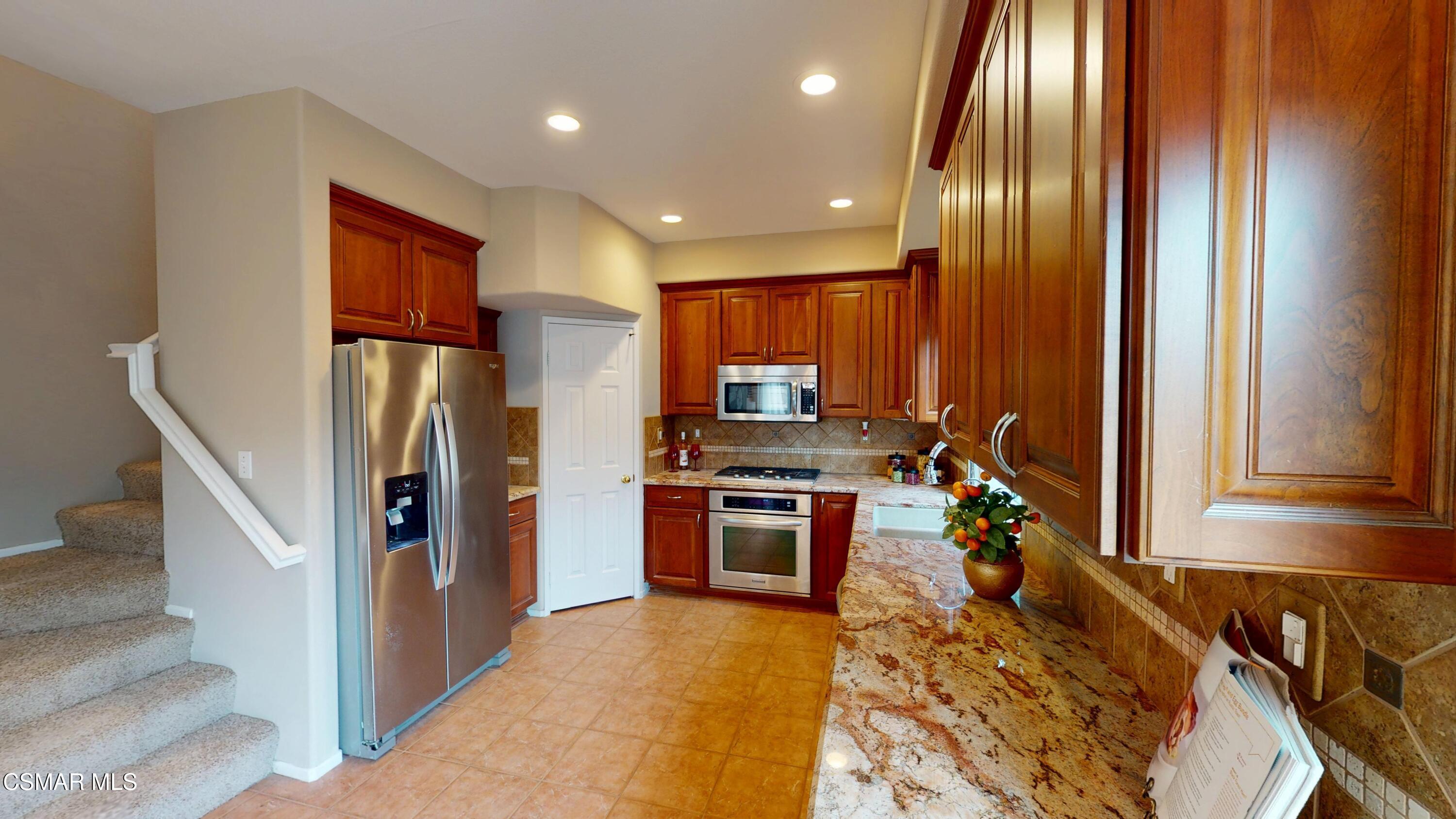 1708 Starpine Way Simi Valley, CA 93065 - Photo 24 of 60 a kitchen with stainless steel appliances granite countertop a refrigerator and a stove top oven