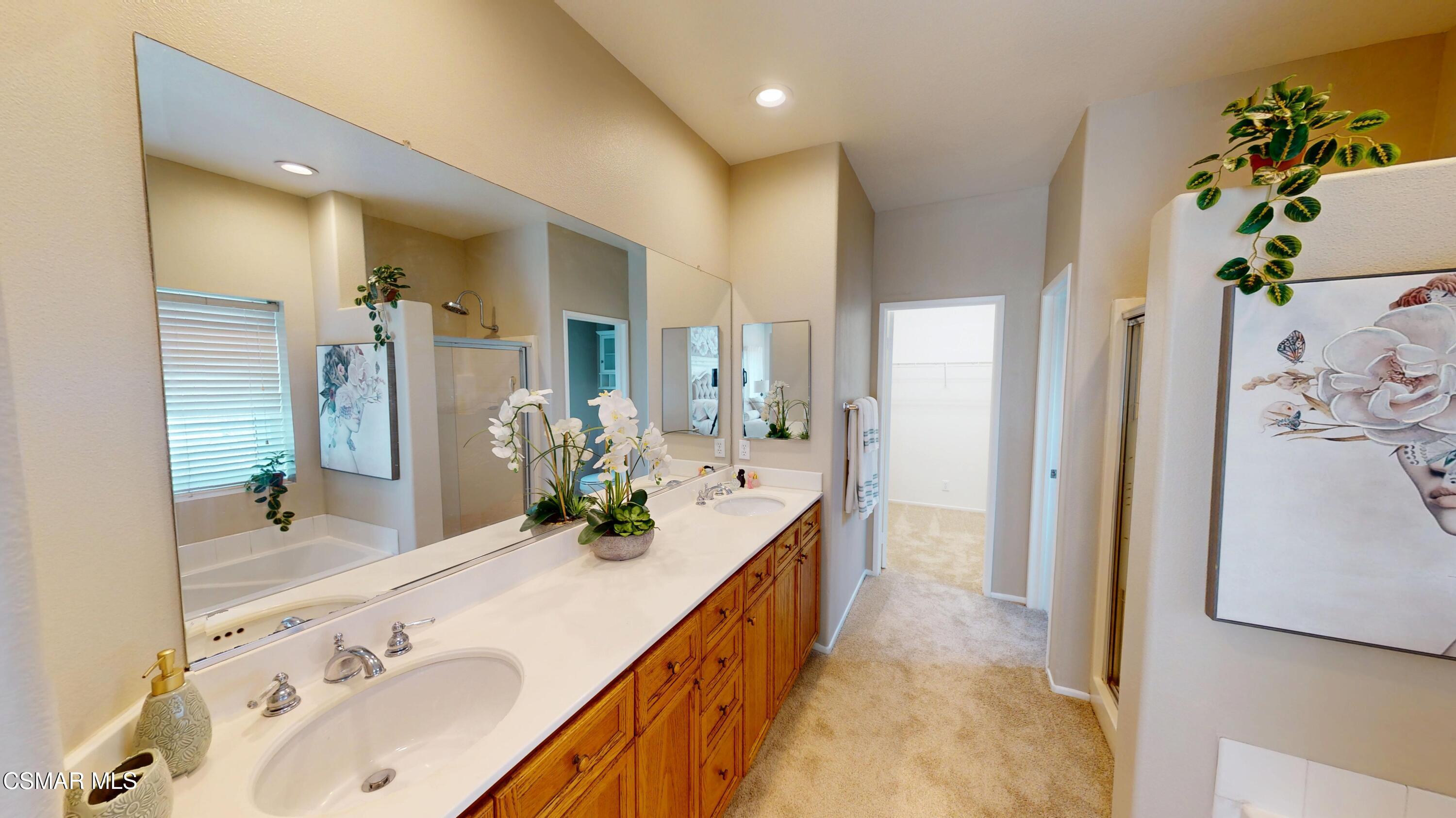 1708 Starpine Way Simi Valley, CA 93065 - Photo 32 of 60 a spacious bathroom with a double vanity sink and a mirror
