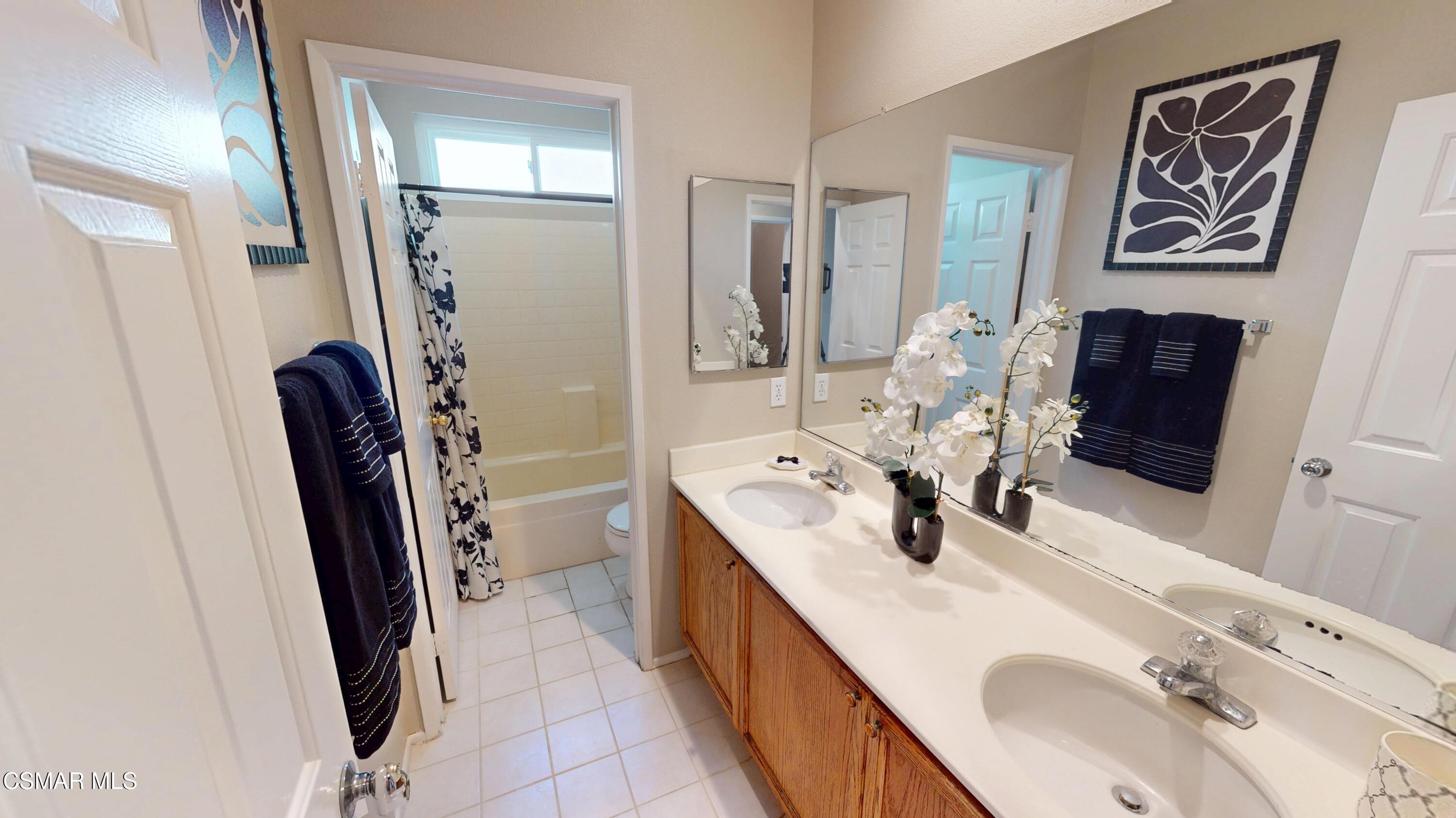 1708 Starpine Way Simi Valley, CA 93065 - Photo 44 of 60 a bathroom with double vanity sink and a mirror