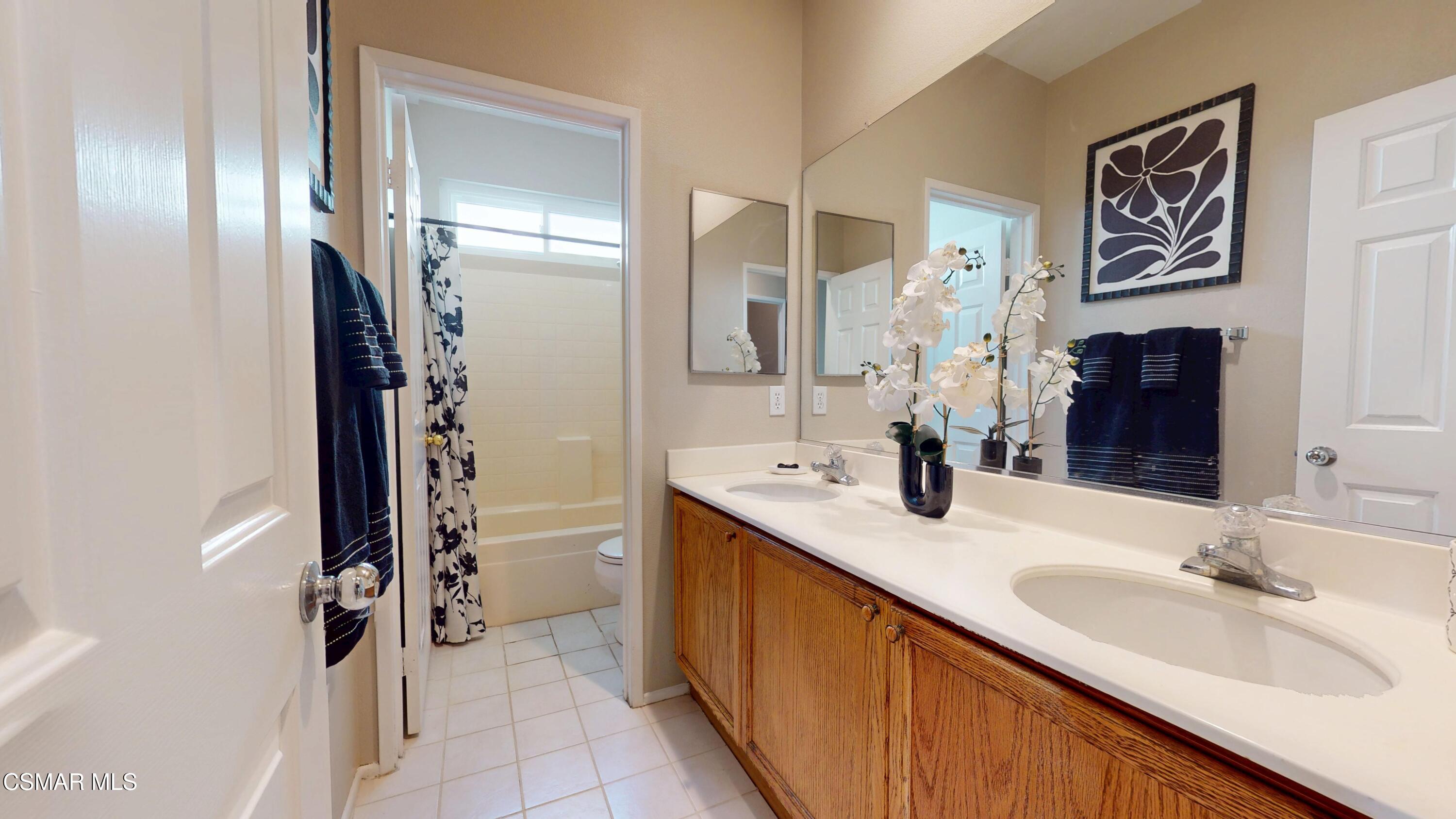 1708 Starpine Way Simi Valley, CA 93065 - Photo 45 of 60 a bathroom with a double vanity sink mirror and shower