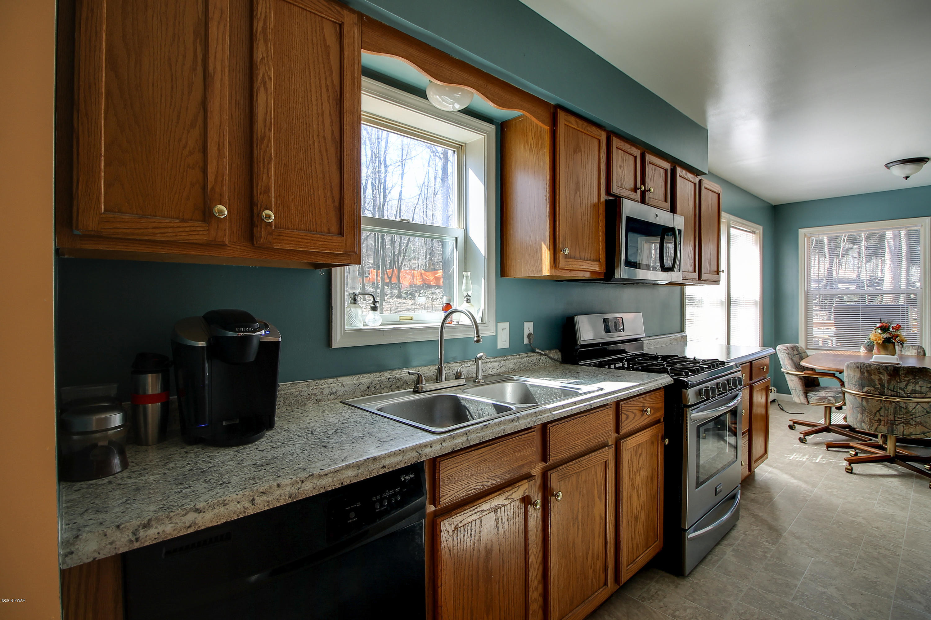 5630 Haas Pond Road Moscow, PA 18444 - Photo 11 of 42 a kitchen with a sink stove and cabinets