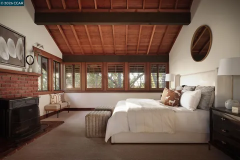 a bedroom with a bed and a large window