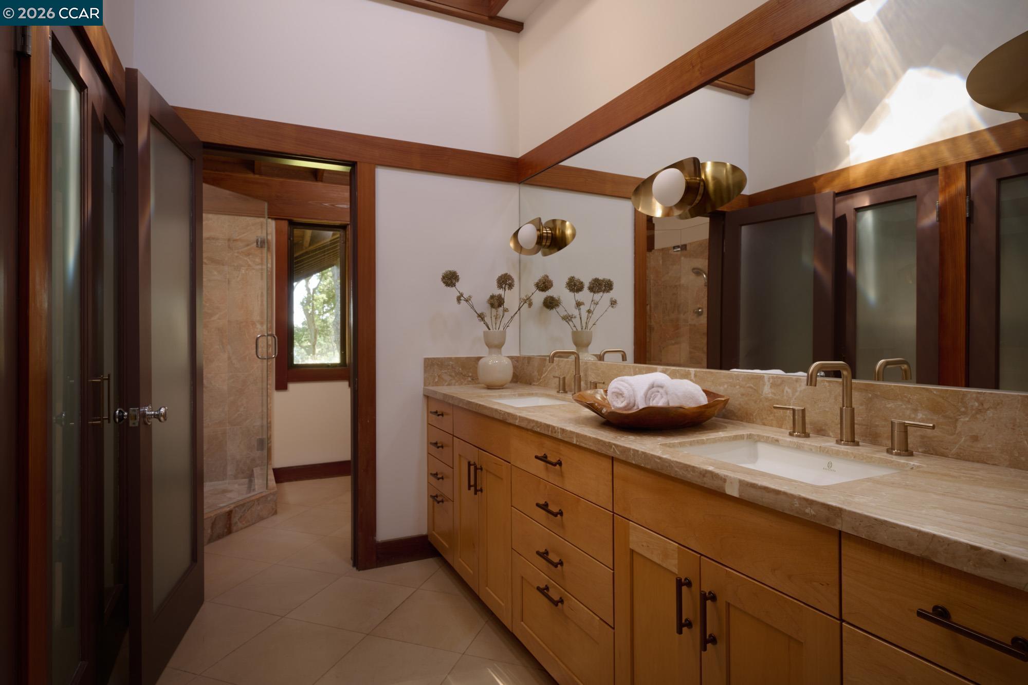 289 Castle Crest Road Alamo, CA 94507 - Photo 36 of 57 a bathroom with a double vanity sink and a mirror
