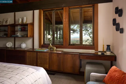 a view of swimming pool with lawn chairs and plants