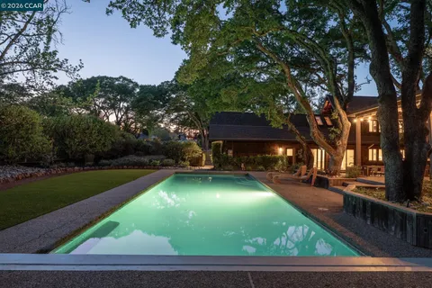 an aerial view of lake residential house with outdoor space and mountain view