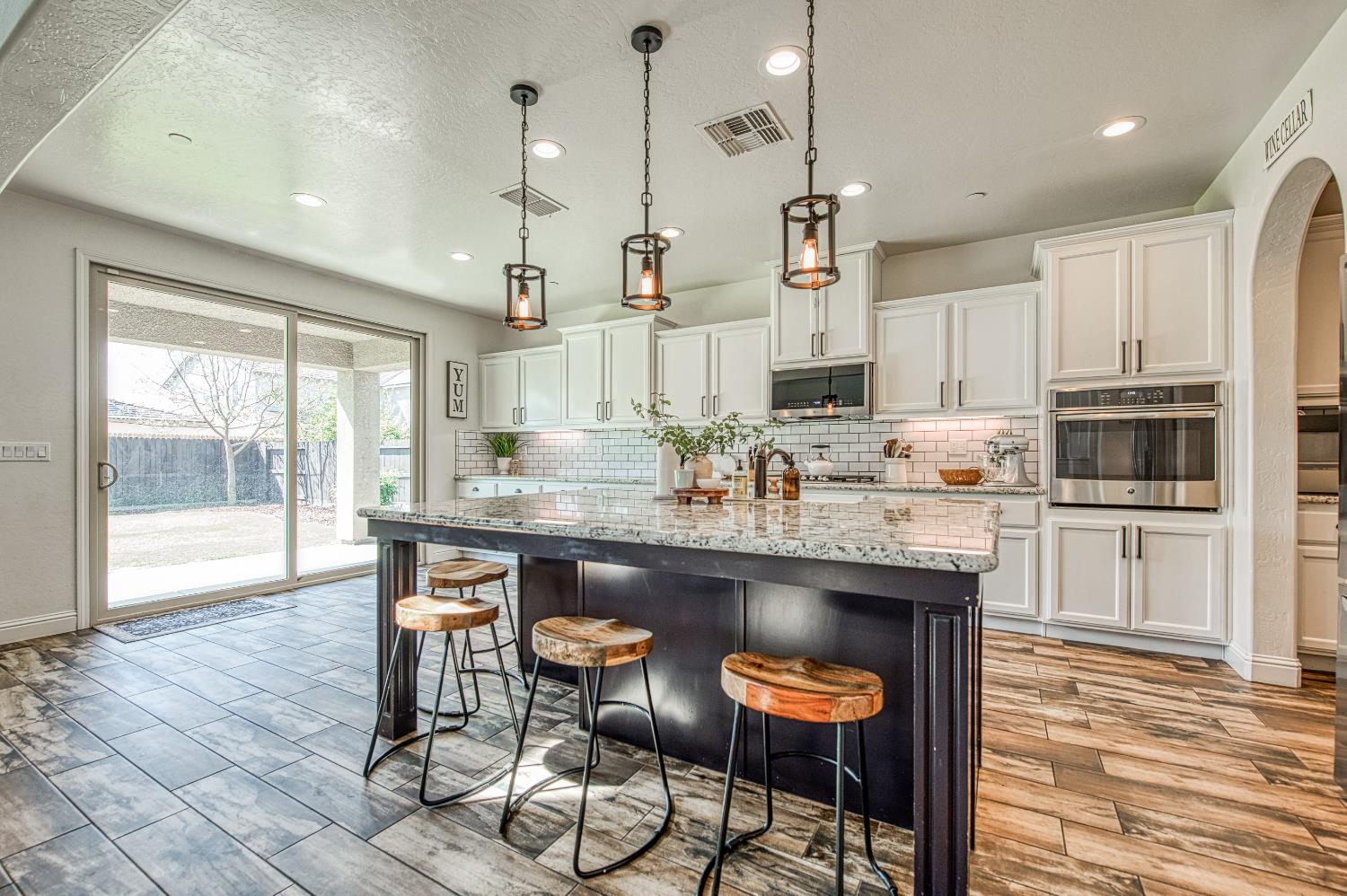 753 East Aretha Avenue Fowler, CA 93625 - Photo 15 of 61 a kitchen with stainless steel appliances granite countertop a stove a refrigerator a oven a sink with a dining table and chairs