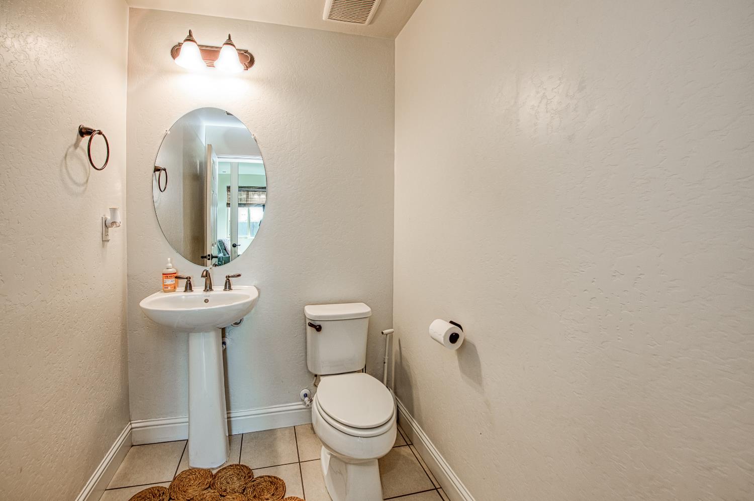 753 East Aretha Avenue Fowler, CA 93625 - Photo 31 of 61 a bathroom with a toilet sink and mirror