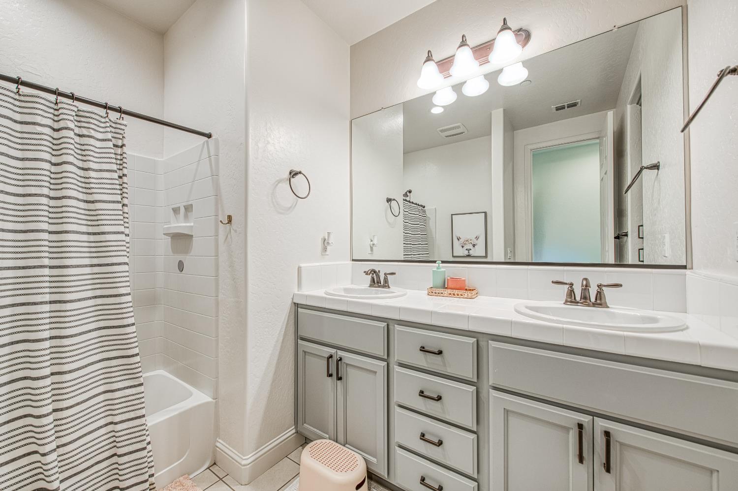 753 East Aretha Avenue Fowler, CA 93625 - Photo 43 of 61 a bathroom with a double vanity sink mirror and