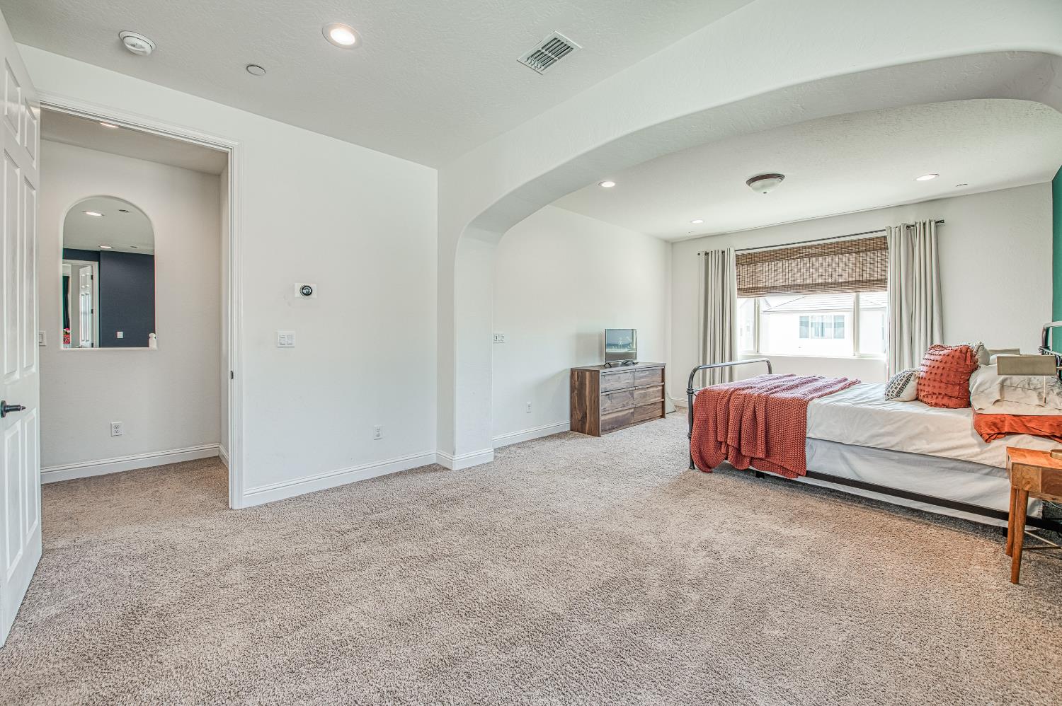 753 East Aretha Avenue Fowler, CA 93625 - Photo 52 of 61 a spacious bedroom with a bed and a couch
